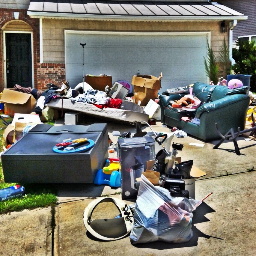 Garage junk waiting for removal by Stand Up Guys Junk Removal.