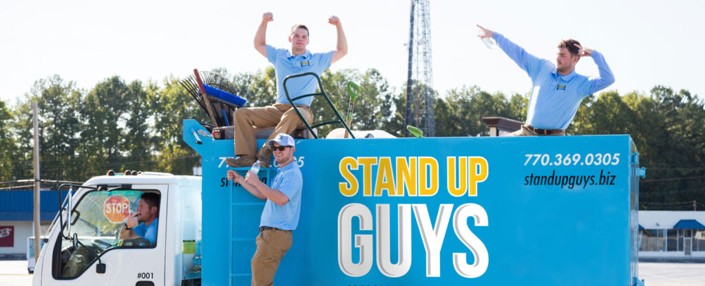 Stand Up Guys Junk Removal crew with a truck used for hauling and dumpster services.