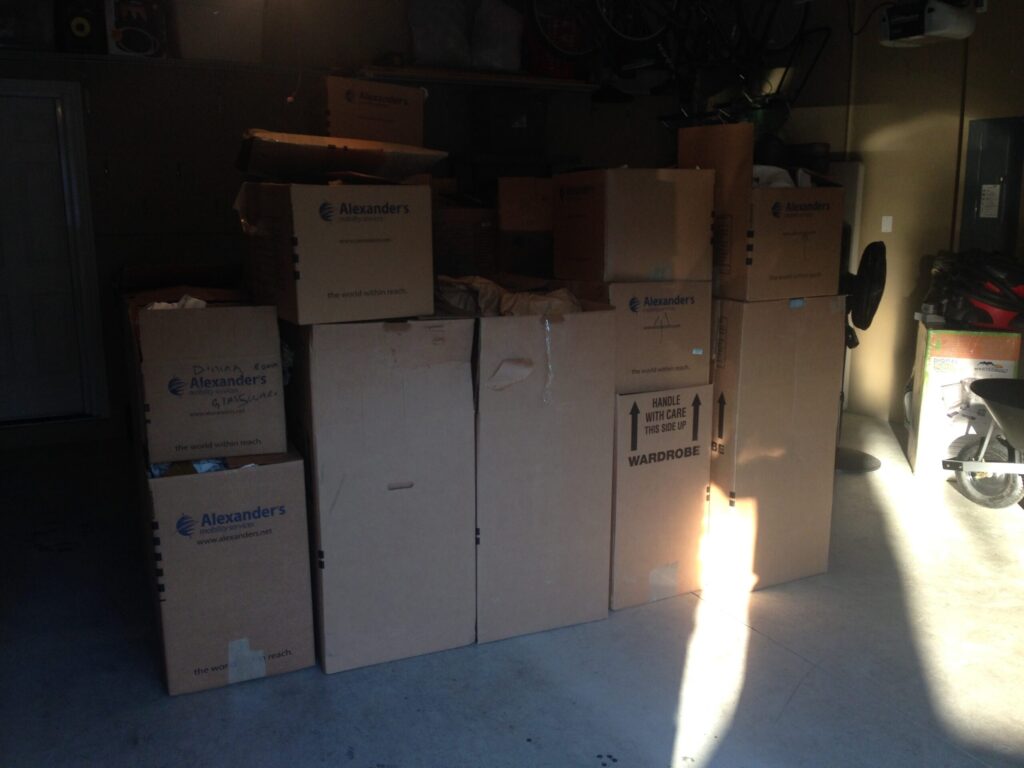 Boxes of leftover moving junk ready for Stand Up Guys Junk Removal services.