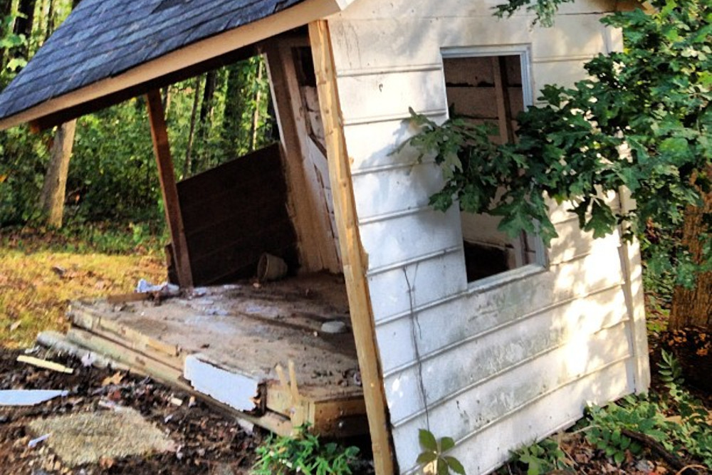 Half torn down shed.